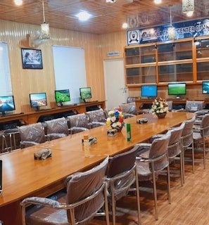 Portraits of IFIP CAI members engaged in discussion in a modern research lab environment.